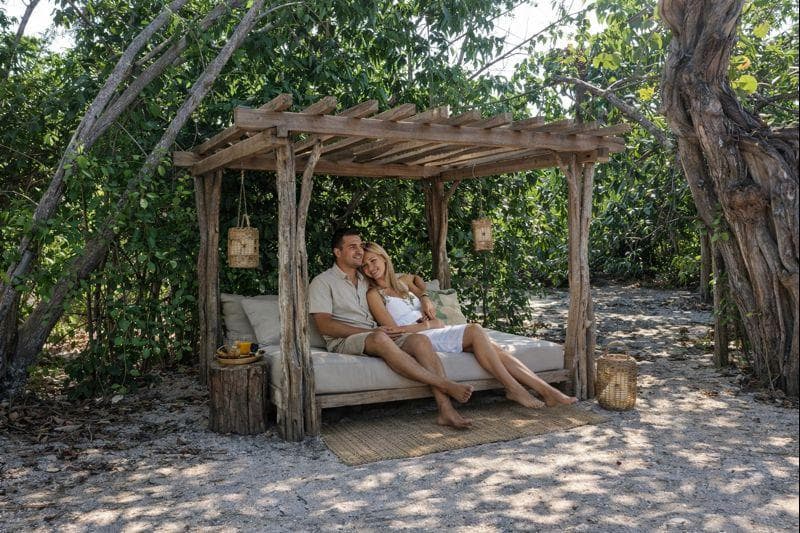 Couple relaxing on daybed